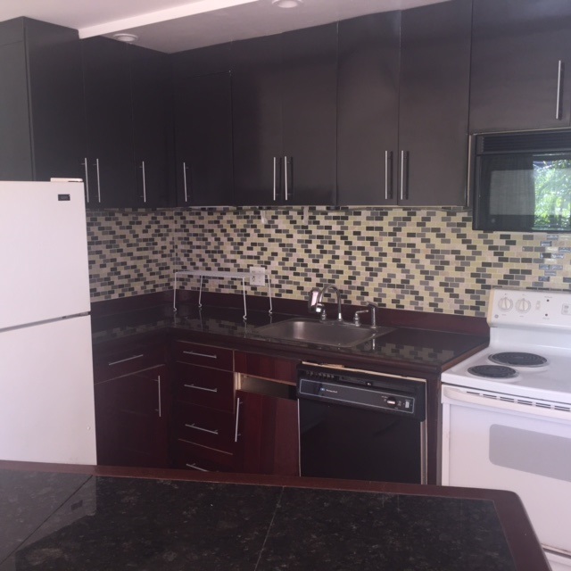 3559 Lower Honoapiilani Road, Unit 718 Lahaina, HI 96761 - Photo 9 of 23 a kitchen with a sink and a stove
