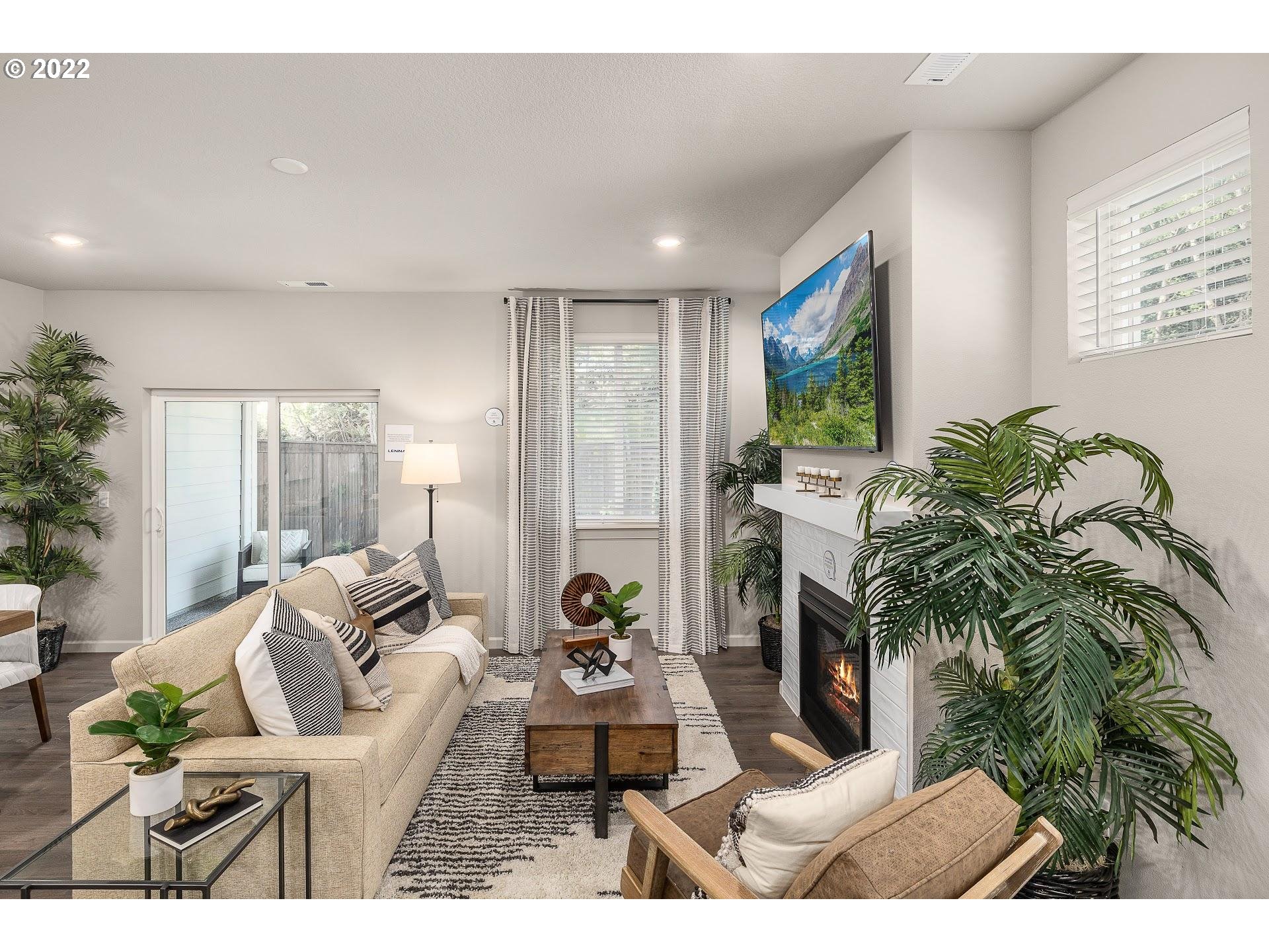 2408 South Brookside Place Ridgefield, WA 98642 - Photo 11 of 32 a living room with furniture and a potted plant