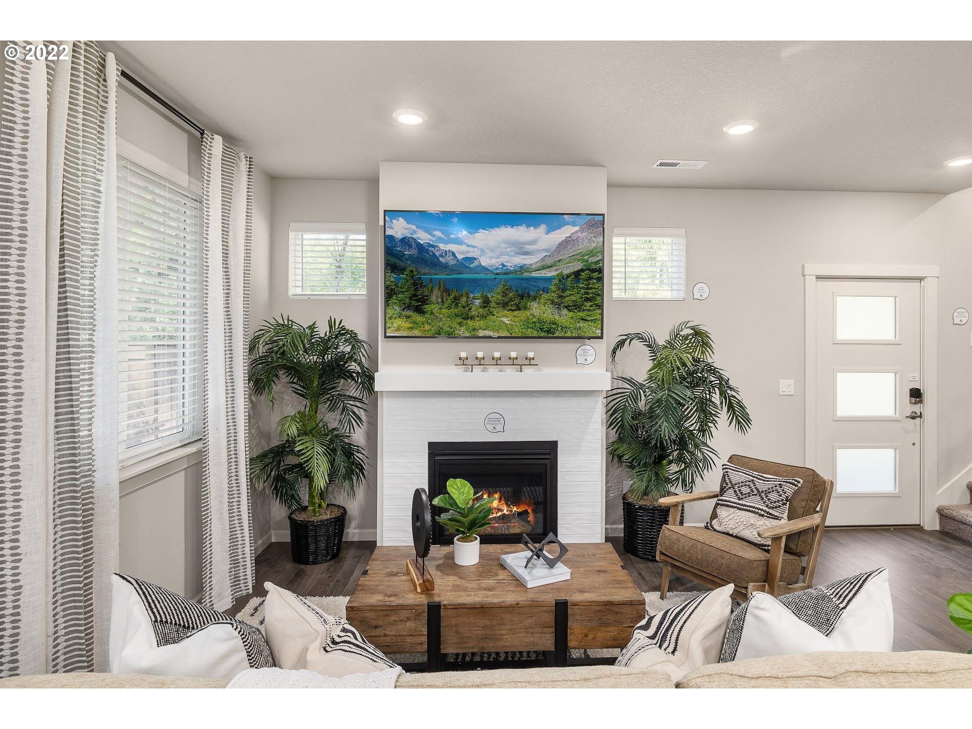 2408 South Brookside Place Ridgefield, WA 98642 - Photo 12 of 32 a living room with furniture a fireplace and a potted plant