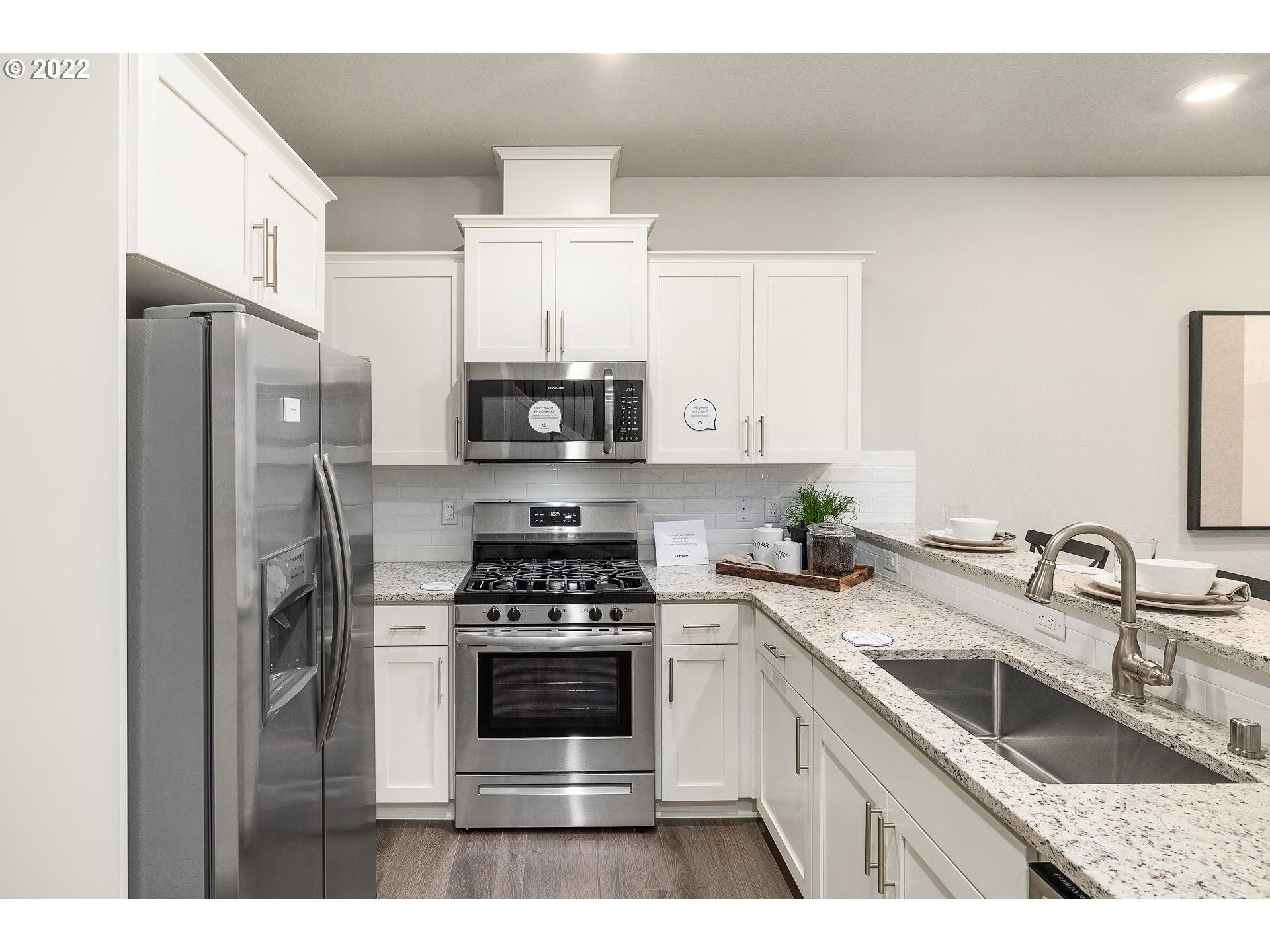 2408 South Brookside Place Ridgefield, WA 98642 - Photo 15 of 32 a kitchen with stainless steel appliances a sink stove and refrigerator