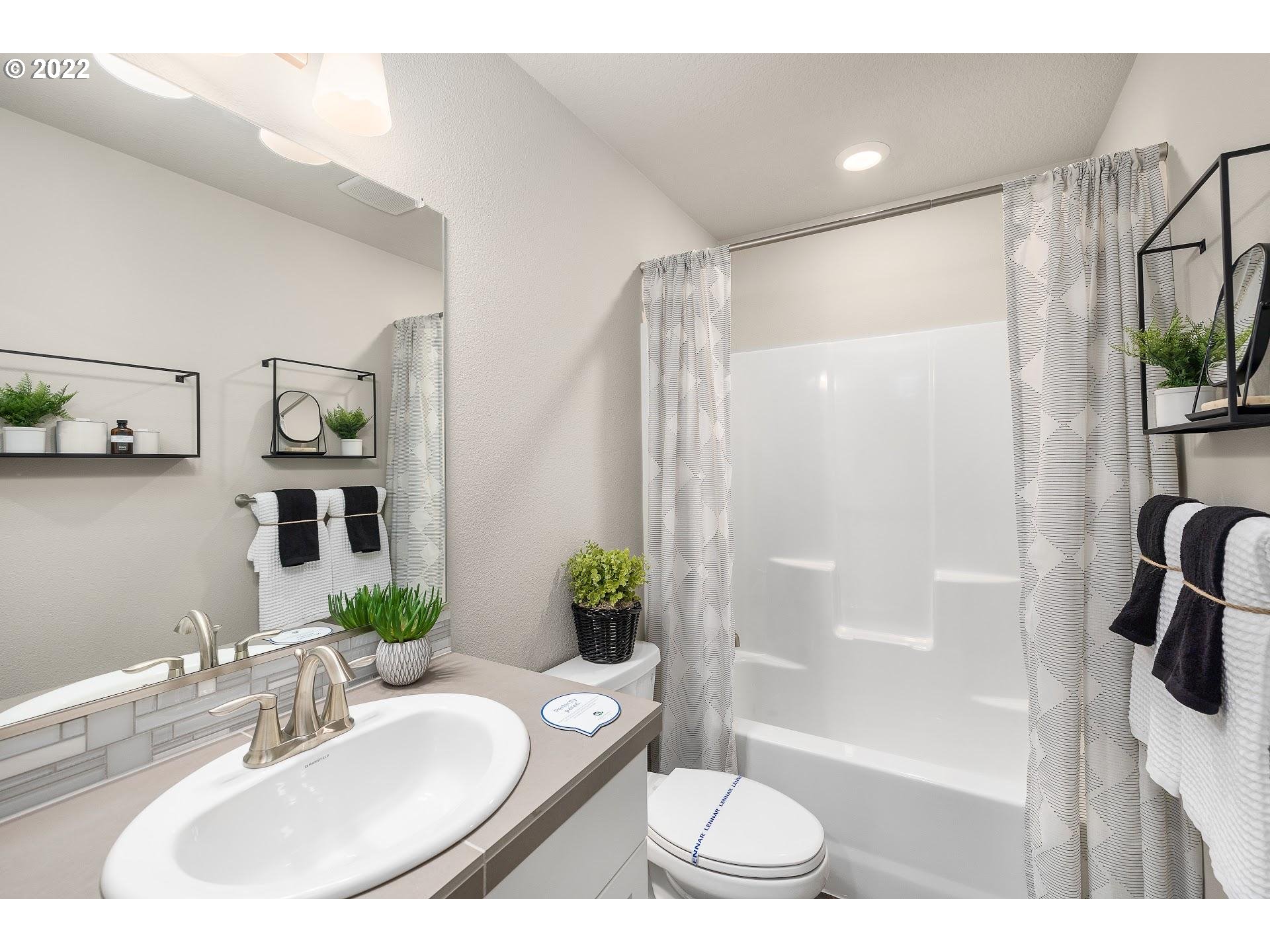 2408 South Brookside Place Ridgefield, WA 98642 - Photo 21 of 32 a bathroom with a sink and a mirror