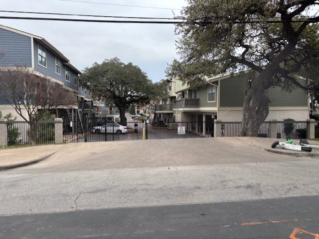 2215 Post Road, Unit 2044 Austin, TX 78704 - Photo 28 of 34 Secure gated entry highlights this residential community surrounded by mature shade trees.