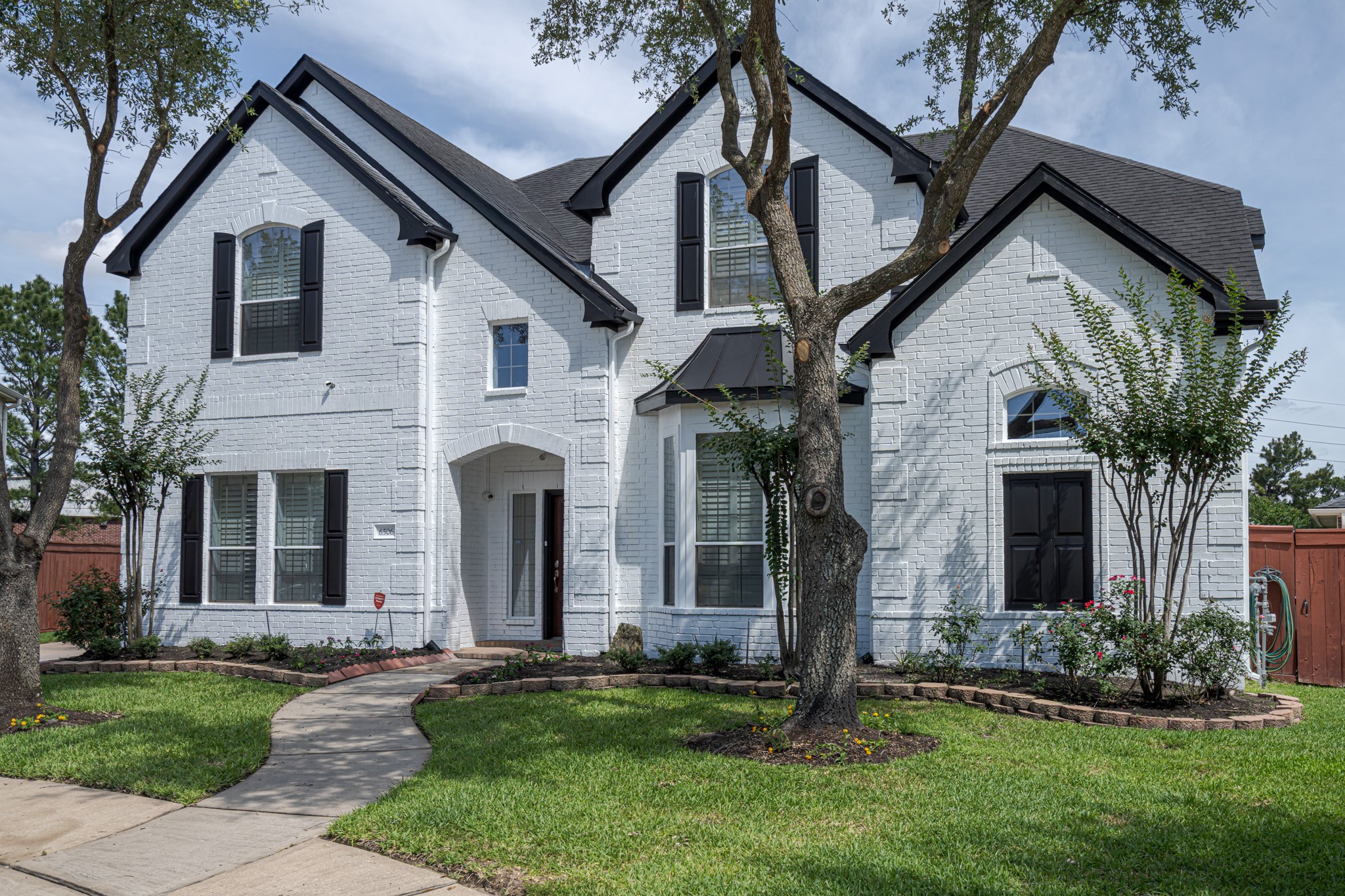 6506 Monte Bello Ridge Lane Houston, TX 77041 - Photo 32 of 39 white brick exterior with black shutters