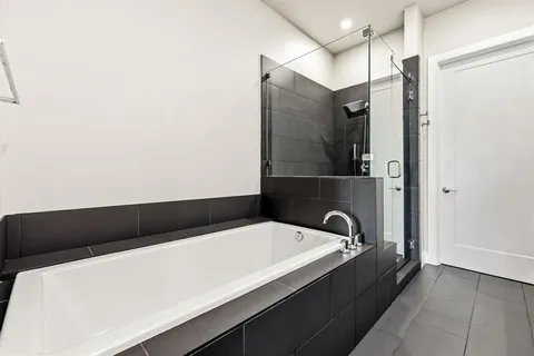 a bathroom with a bathtub and shower