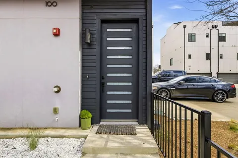a view of a door and car parked in front of a house