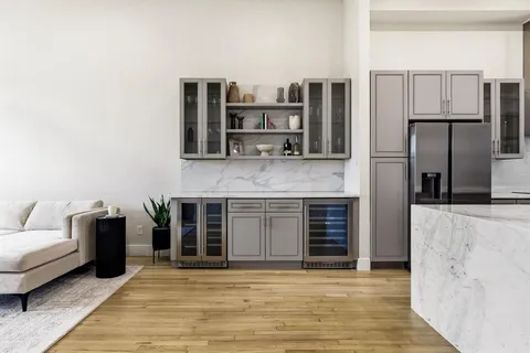 a view of kitchen with stainless steel appliances kitchen island granite countertop a refrigerator and a stove top oven
