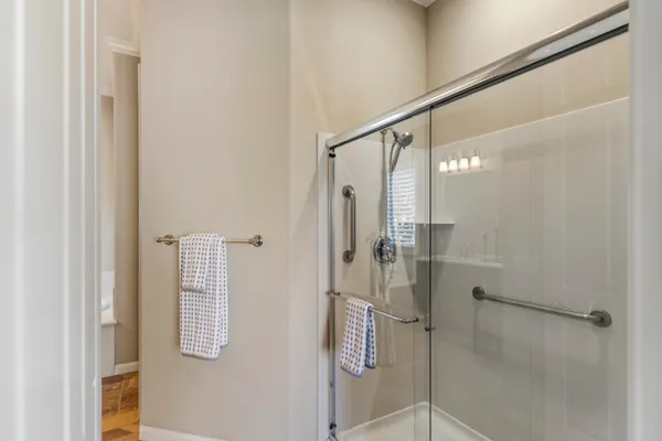 a bathroom with a shower and a mirror