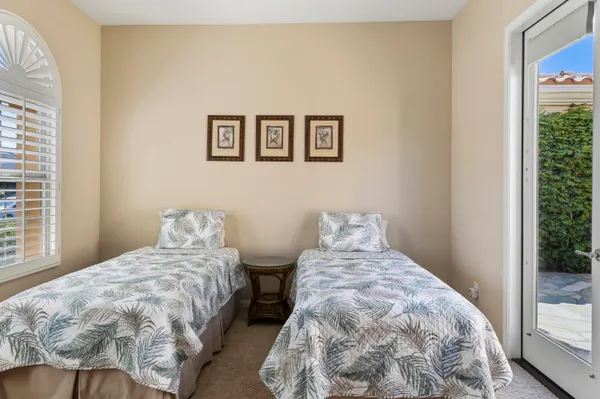 a bedroom with two beds and a window