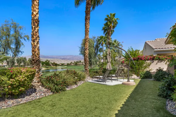 a view of a chair and table in the garden