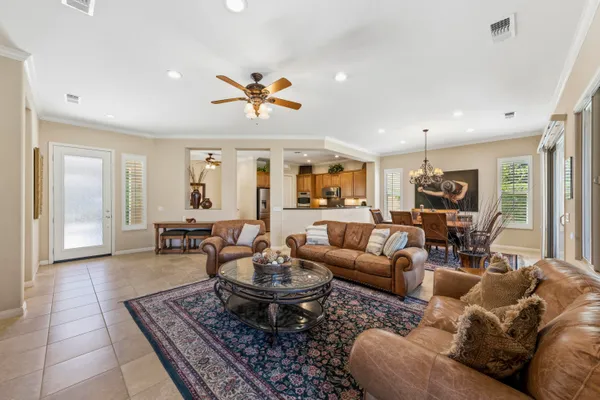 a living room with furniture potted plant and a window