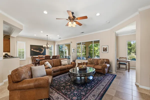 a living room with furniture a rug and a large window