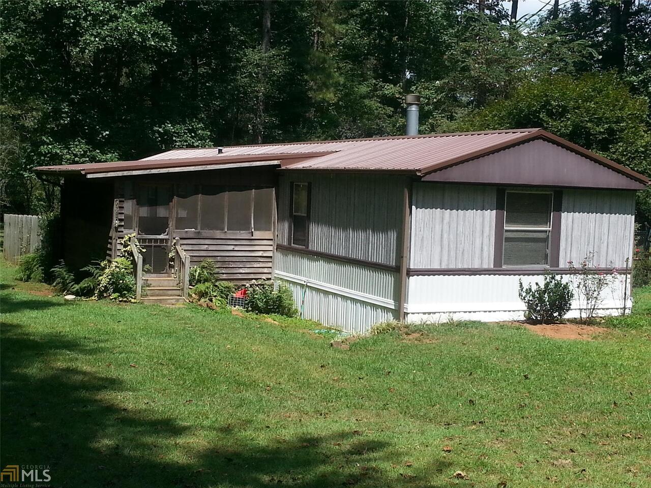 2105 Pope Road Villa Rica, GA 30180 - Photo 1 of 1 a front view of a house with a yard