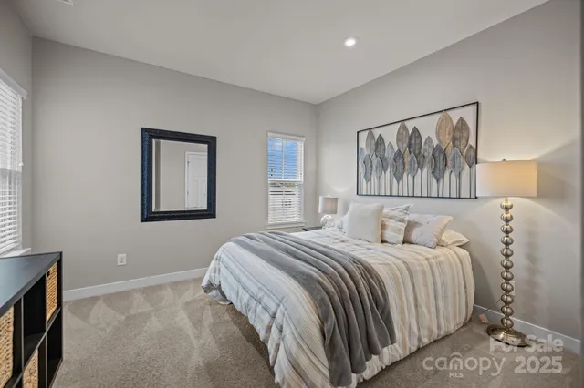 a bedroom with a large bed and a chandelier