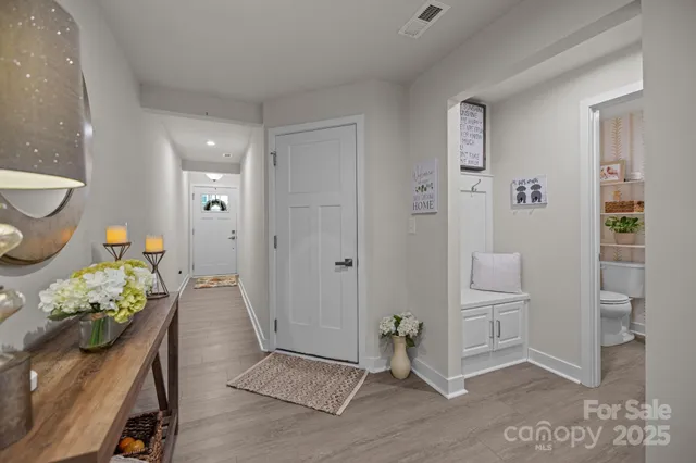 a living room with furniture a rug and kitchen view