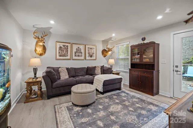 a kitchen with stainless steel appliances granite countertop a stove a refrigerator a sink a dining table and chairs