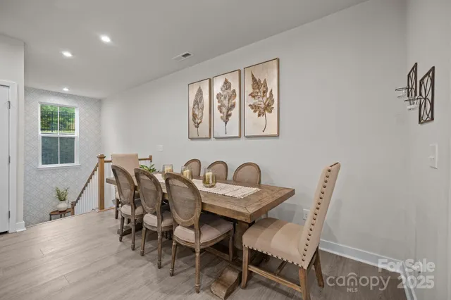 a large kitchen with kitchen island a stove a sink a refrigerator and a wooden floor