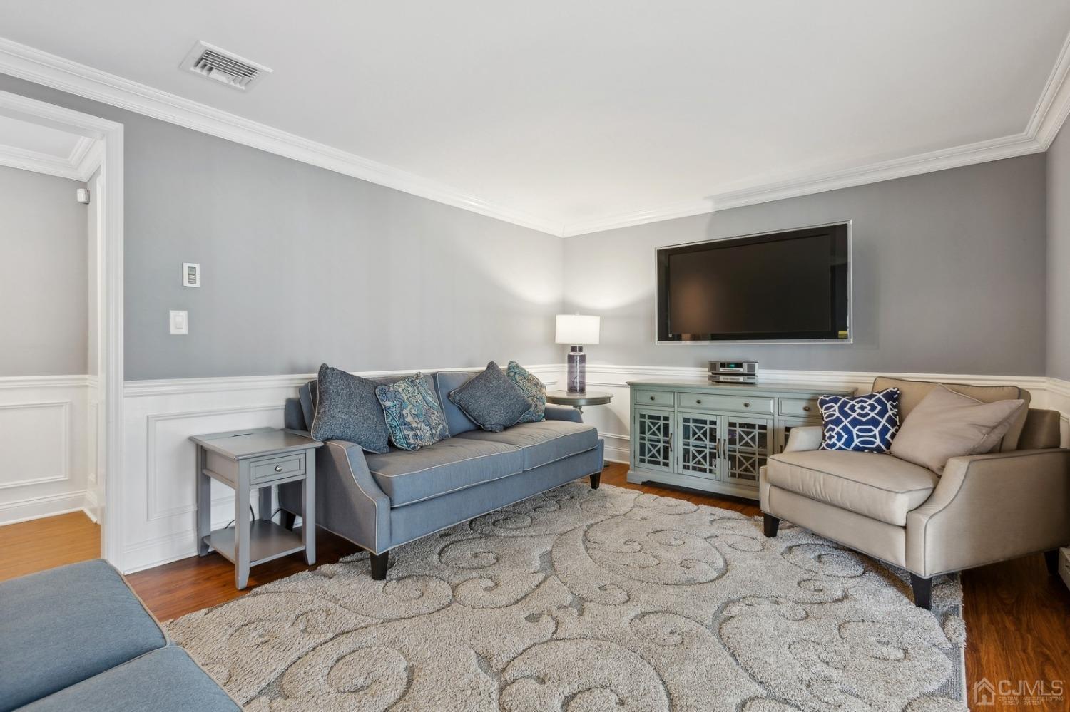 33 King Street Edison, NJ 08820 - Photo 22 of 44 a living room with furniture and a flat screen tv