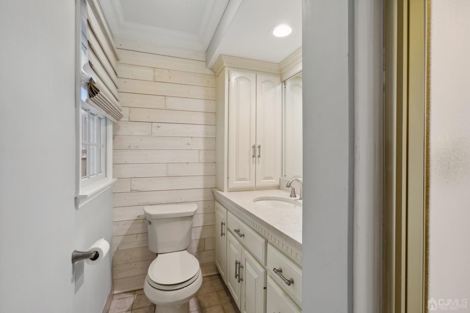 33 King Street Edison, NJ 08820 - Photo 26 of 44 a bathroom with a granite countertop toilet a sink and a mirror
