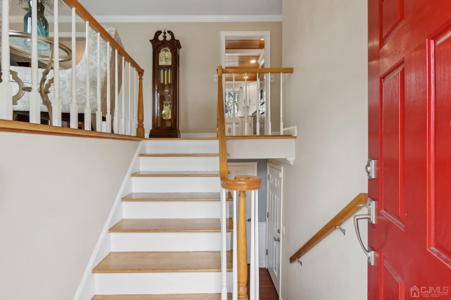 33 King Street Edison, NJ 08820 - Photo 9 of 44 a view of staircase with lots of frames on wall and a window