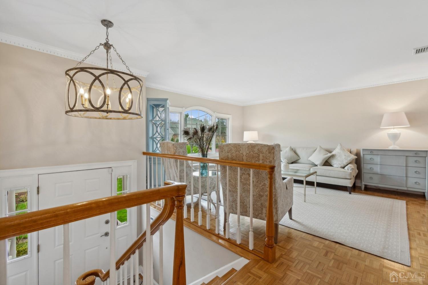 33 King Street Edison, NJ 08820 - Photo 10 of 44 a view of a hallway with an entryway and chandelier