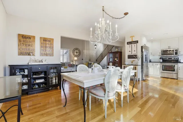 a view of a dining room with furniture and chandelier