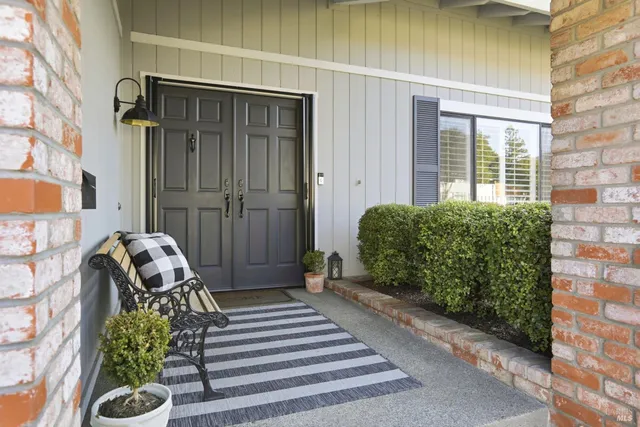 a balcony with furniture and a potted plant