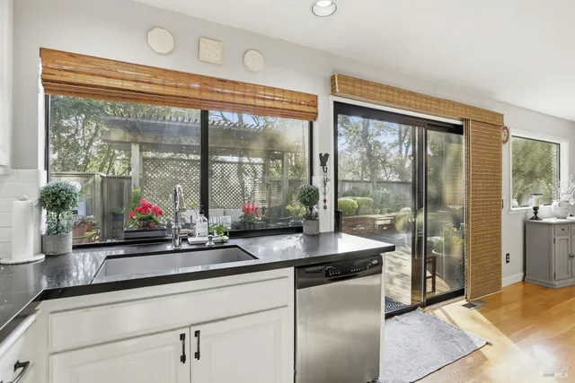 a kitchen with sink and large window