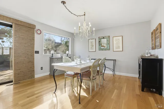 a view of a dining room with furniture and a chandelier