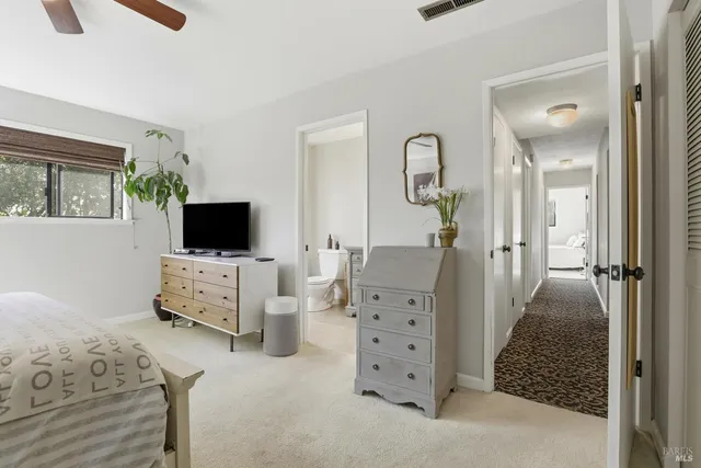 walk in bedroom with furniture and flat screen tv