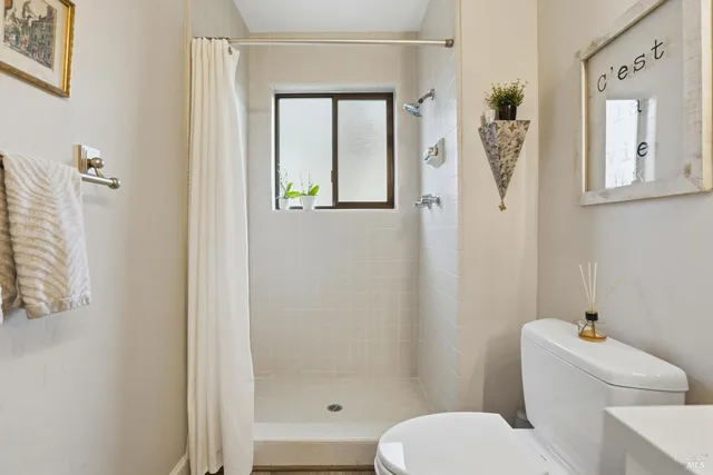 a white toilet sitting next to a bathroom sink