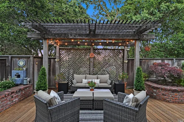 a patio with patio couch and potted plants