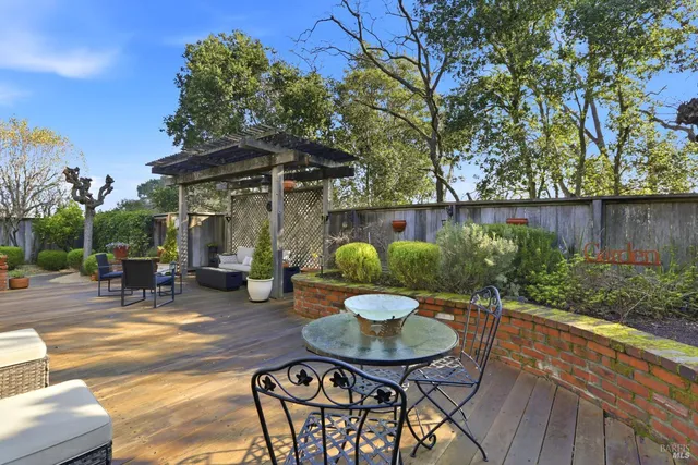 a backyard of a house with table and chairs