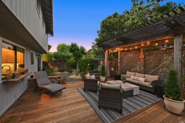 a balcony with wooden floor and outdoor seating