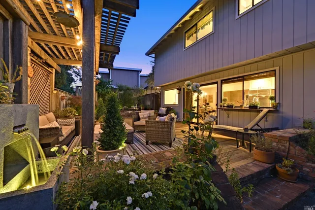 a view of a patio with table and chairs and potted plants