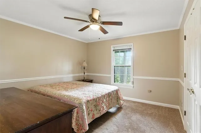 an empty room with a window and a ceiling fan