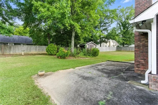 a front view of a house with a garden and yard