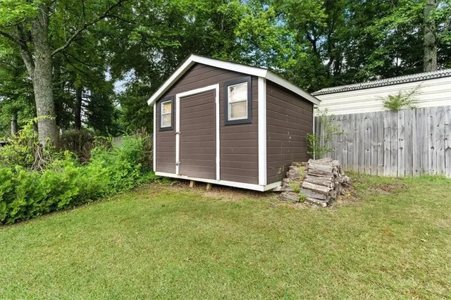 a front view of a house with yard and green space