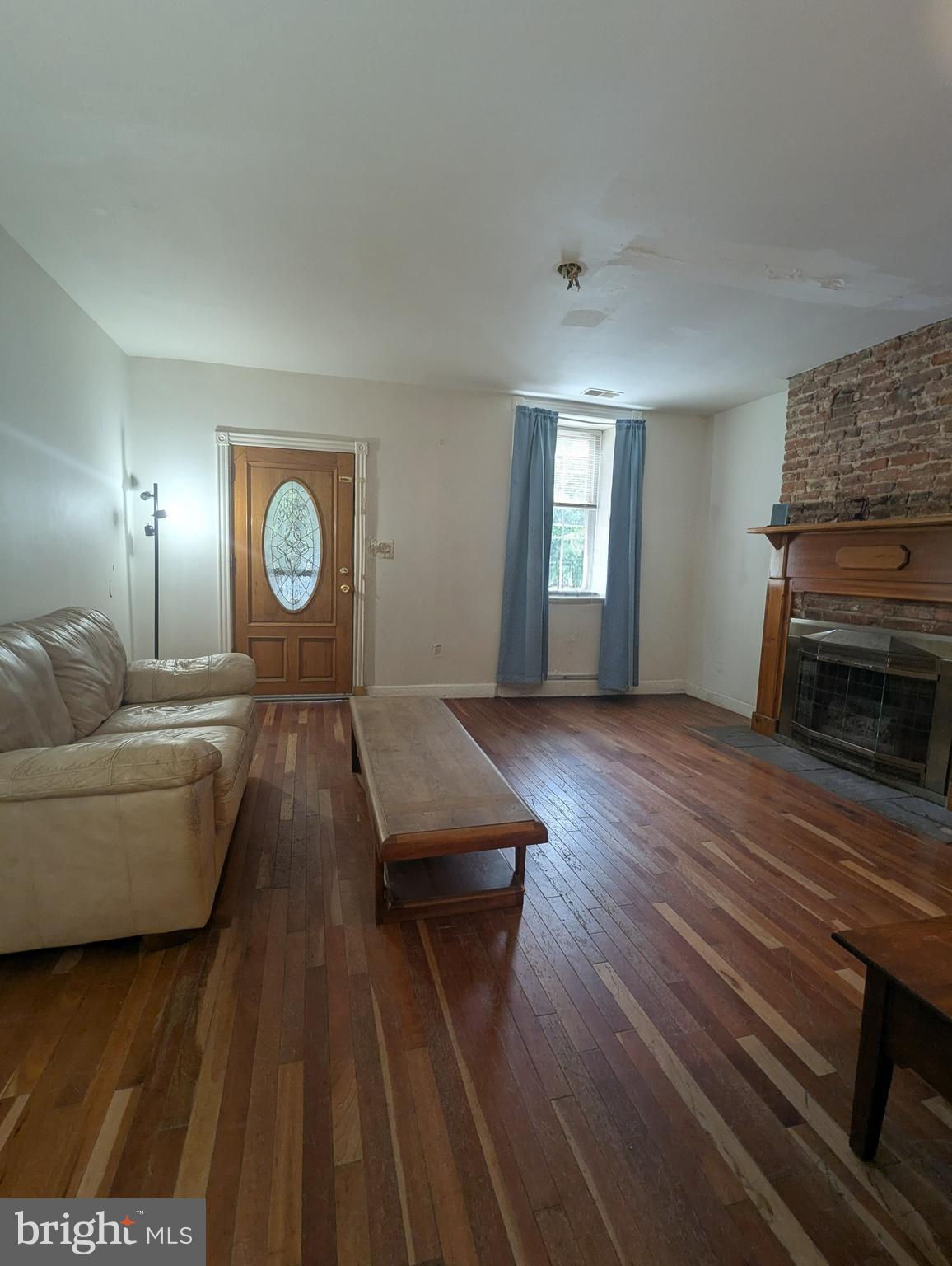 1506 Mill Race Road Baltimore, MD 21211 - Photo 2 of 13 a living room with furniture and a fireplace