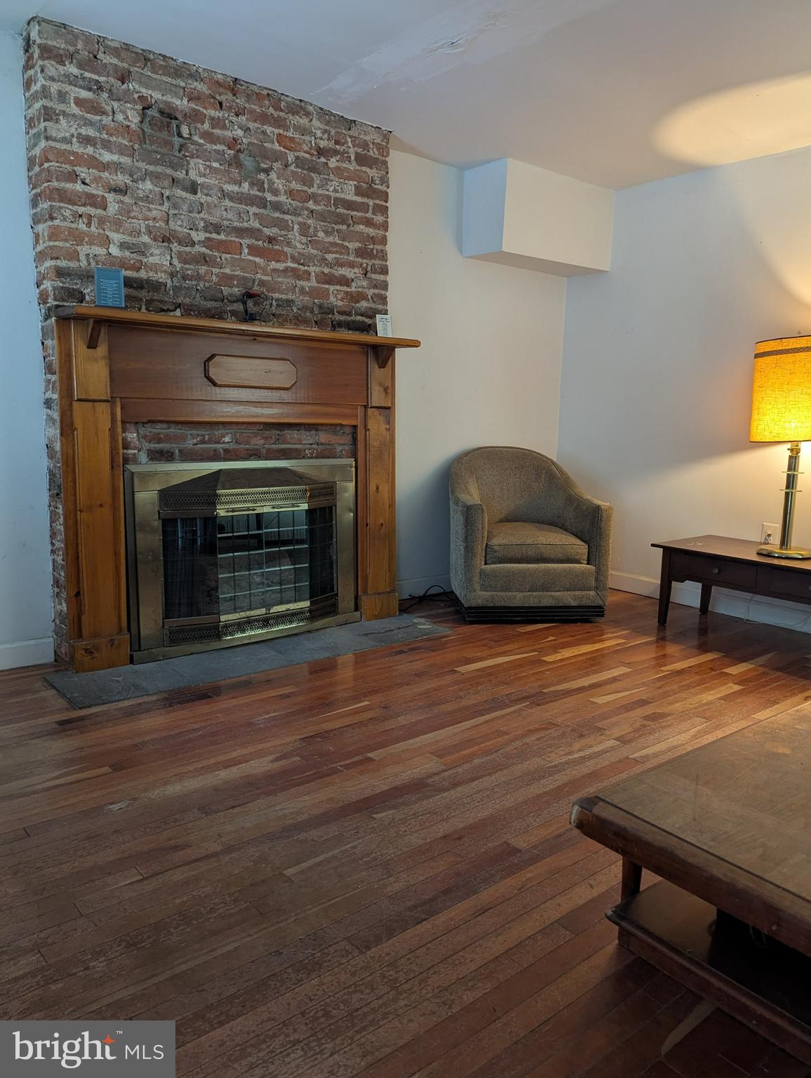 1506 Mill Race Road Baltimore, MD 21211 - Photo 4 of 13 a living room with furniture and a fireplace