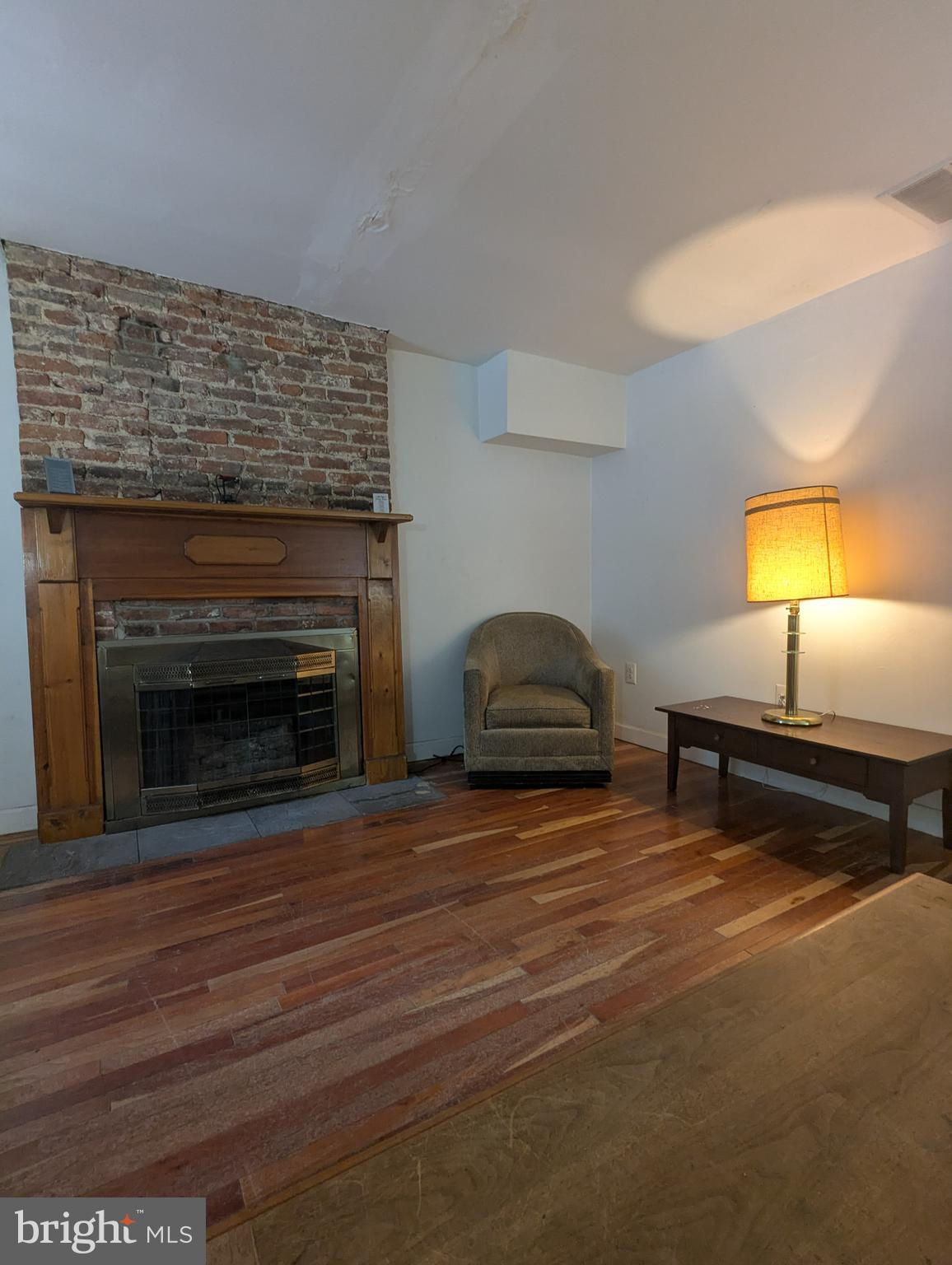 1506 Mill Race Road Baltimore, MD 21211 - Photo 5 of 13 a living room with furniture and a fireplace