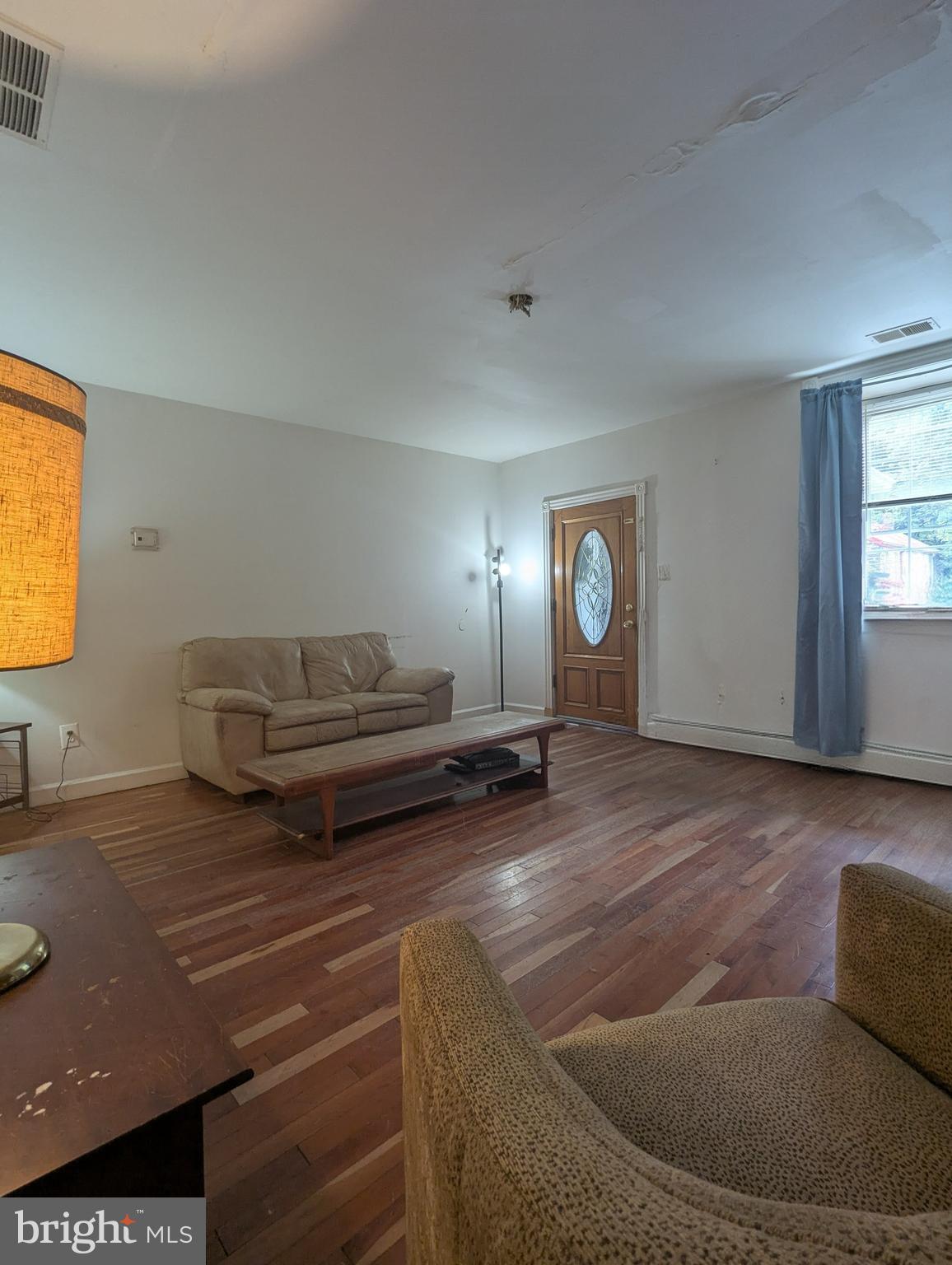 1506 Mill Race Road Baltimore, MD 21211 - Photo 6 of 13 a living room with couches and painting on the wall