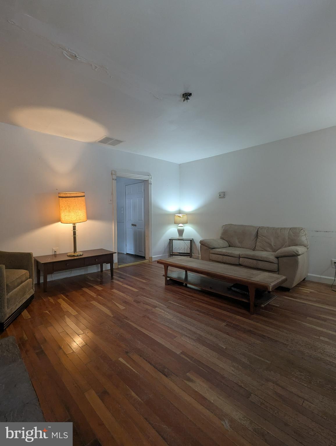 1506 Mill Race Road Baltimore, MD 21211 - Photo 7 of 13 a bedroom with furniture and a wooden floor