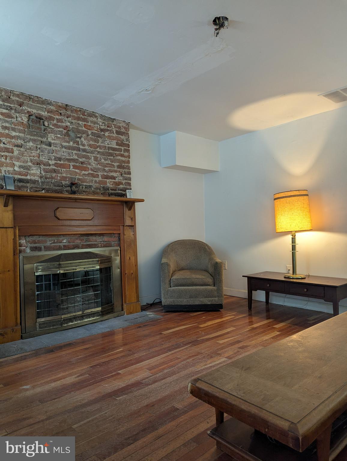1506 Mill Race Road Baltimore, MD 21211 - Photo 8 of 13 a living room with furniture and a fireplace