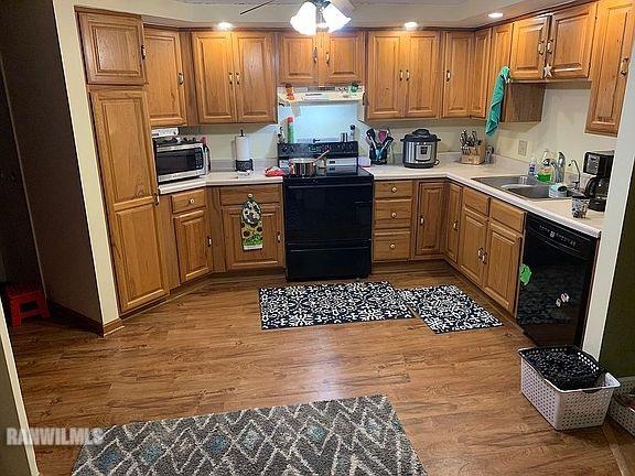 11011 West Nora Road Winslow, IL 61089 - Photo 4 of 20 a kitchen with stainless steel appliances kitchen island granite countertop a refrigerator sink and cabinets
