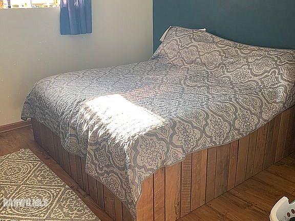 11011 West Nora Road Winslow, IL 61089 - Photo 10 of 20 a bed sitting in a bedroom next to a wooden floor