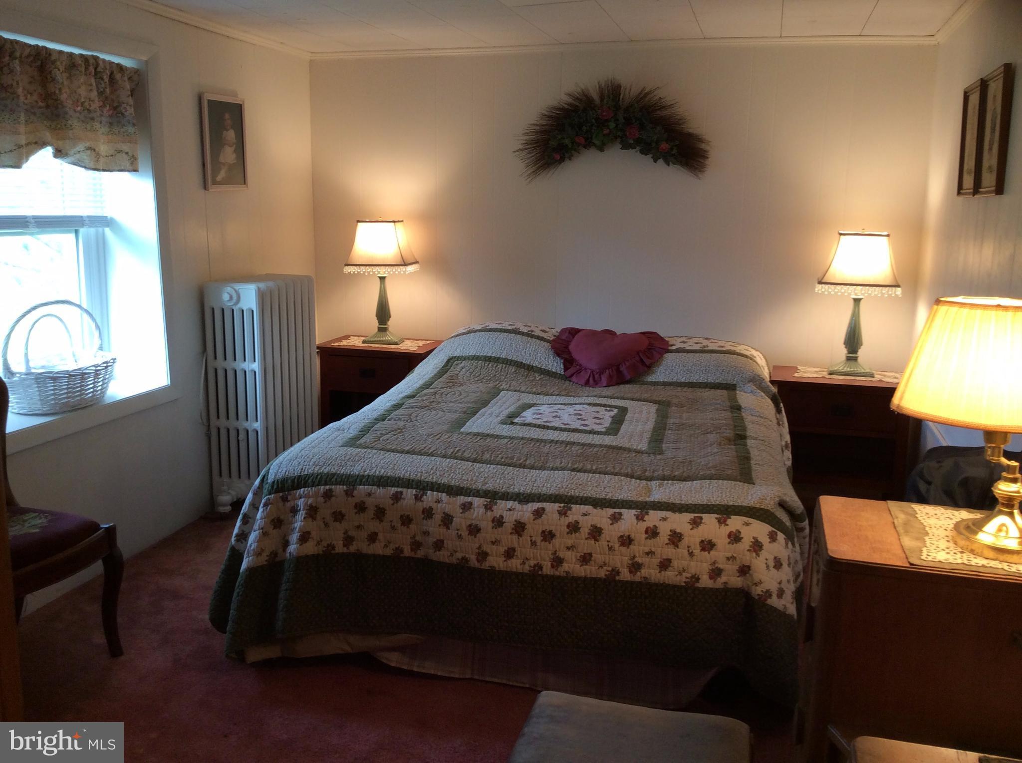 14736 Bottom Road Williamsport, MD 21795 - Photo 14 of 25 a bedroom with a bed window and a lamp