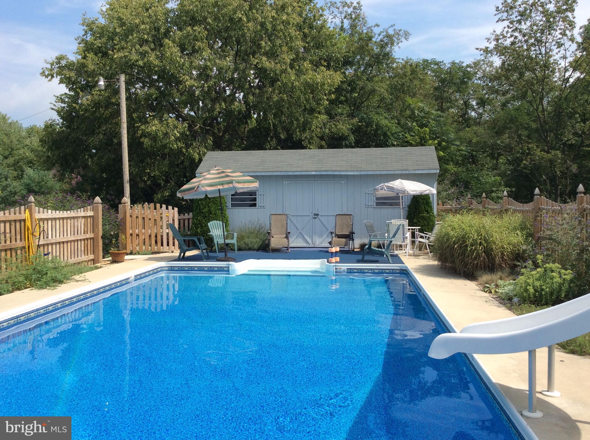 14736 Bottom Road Williamsport, MD 21795 - Photo 23 of 25 a view of a house with pool fire pit tables and chairs