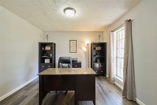 a dining room with furniture and wooden floor