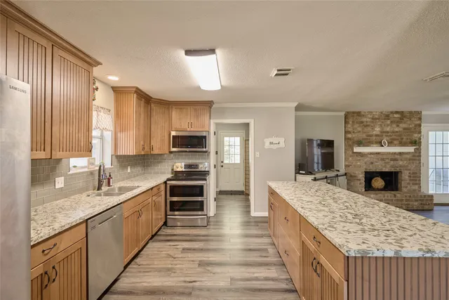 a view of a dining room with furniture wooden floor and a refrigerator