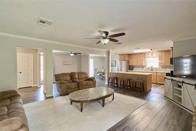 a large kitchen with granite countertop lots of counter top space and stainless steel appliances